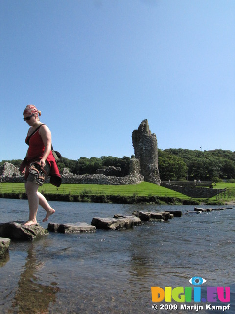 SX07975 Kristina crossing stepping stones at Ogmore Castle